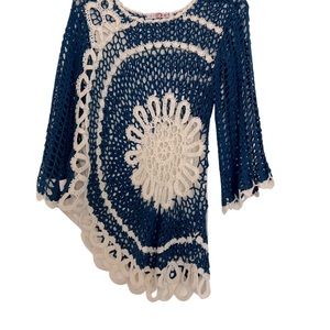 Crocheted shirt or can be used as bathing suit cover up.